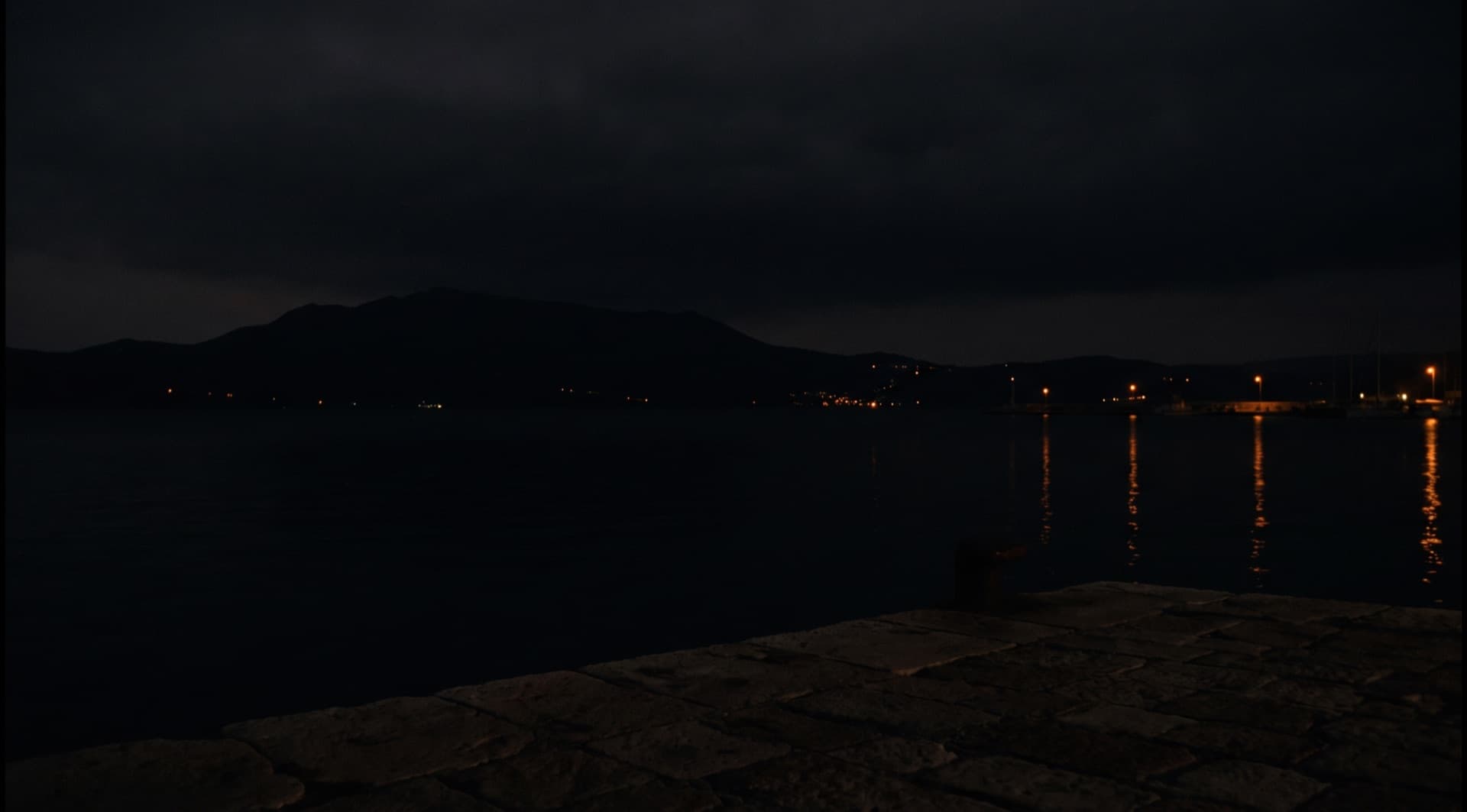 Bodenseeufer bei Nacht, Hafenlichter spiegeln sich im Wasser